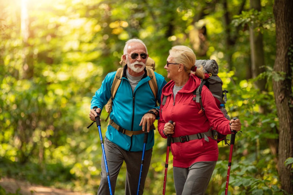 Senior couple is hiking in forest.Adventure, travel,hike and people concept